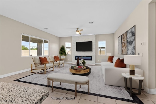 living room with ceiling fan, light tile patterned floors, and a fireplace