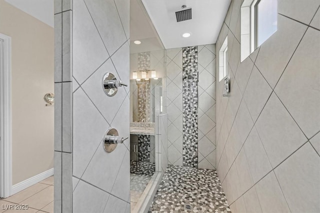 bathroom featuring tile patterned floors and tiled shower