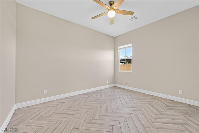 unfurnished room with ceiling fan and light parquet flooring