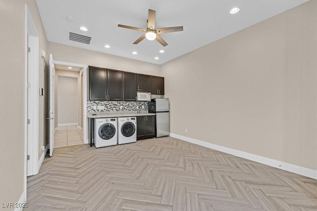 laundry room featuring ceiling fan, separate washer and dryer, and light parquet flooring