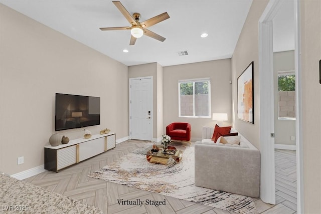 living room with ceiling fan and light parquet flooring