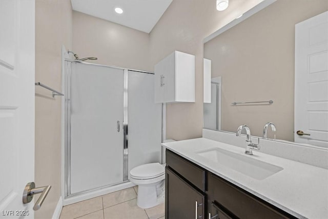 bathroom featuring tile patterned floors, vanity, toilet, and walk in shower