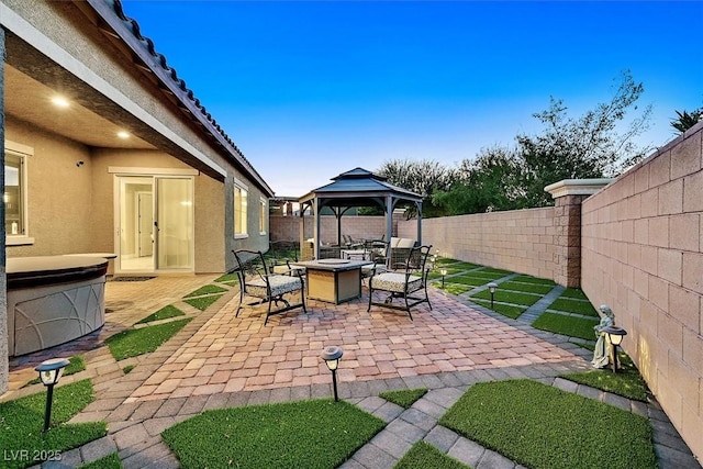 view of patio featuring a gazebo and an outdoor fire pit