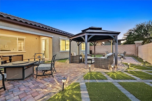 view of patio featuring an outdoor living space with a fire pit and a gazebo