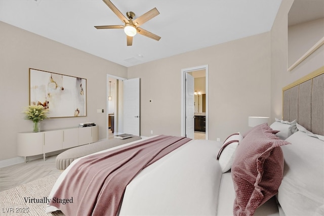 bedroom featuring ceiling fan, light parquet floors, and connected bathroom