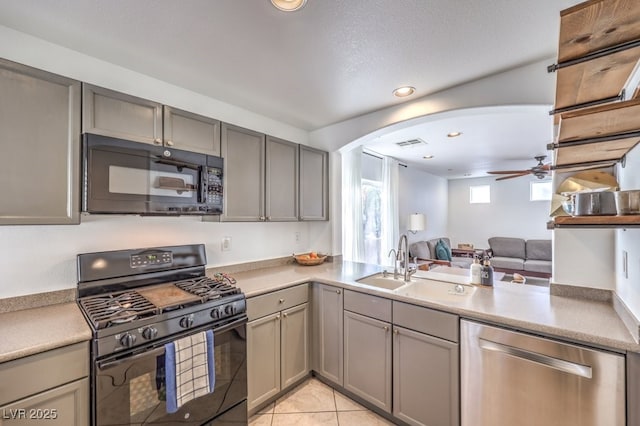 kitchen with ceiling fan, gray cabinets, black appliances, sink, and light tile patterned floors