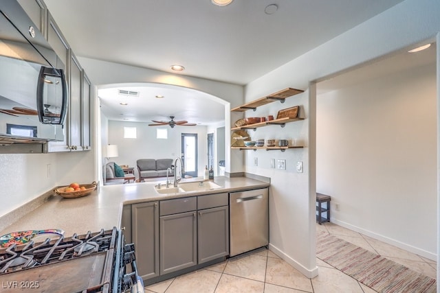 kitchen with dishwasher, gas stove, sink, gray cabinets, and light tile patterned floors