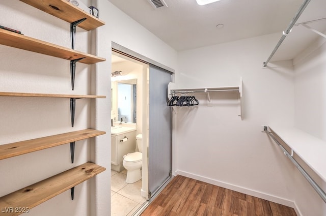 walk in closet featuring wood-type flooring