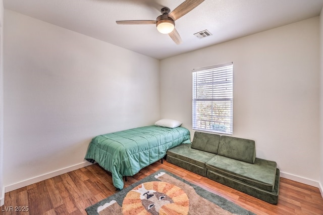 bedroom with ceiling fan and hardwood / wood-style flooring