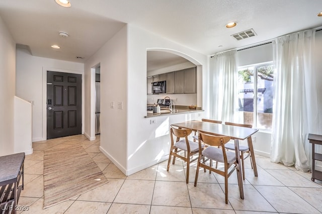 dining space with light tile patterned floors