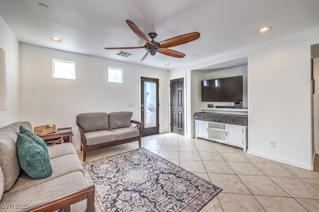 living room featuring ceiling fan, light tile patterned floors, and french doors