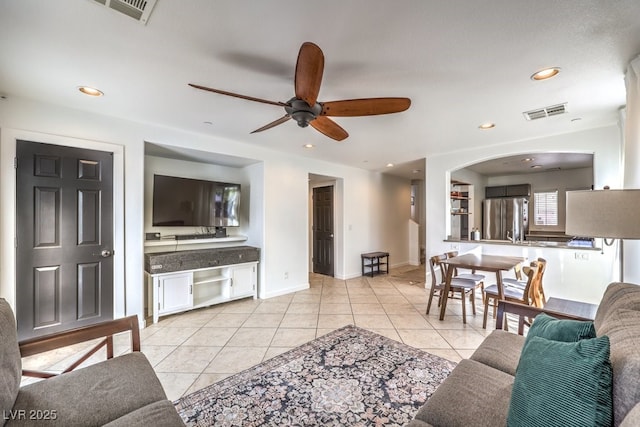 tiled living room with ceiling fan