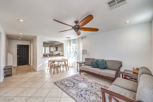 tiled living room with ceiling fan