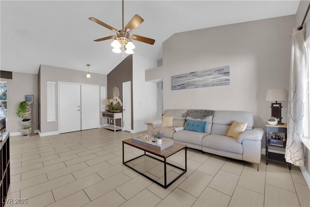 living room featuring ceiling fan and high vaulted ceiling