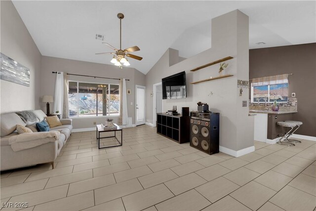 tiled living room featuring ceiling fan and high vaulted ceiling