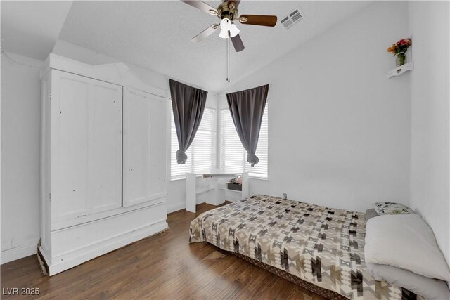 bedroom featuring ceiling fan, vaulted ceiling, and dark hardwood / wood-style flooring