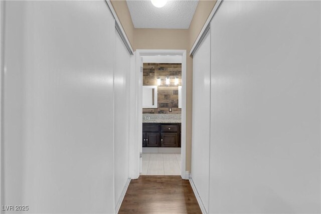 hall featuring dark hardwood / wood-style floors and a textured ceiling