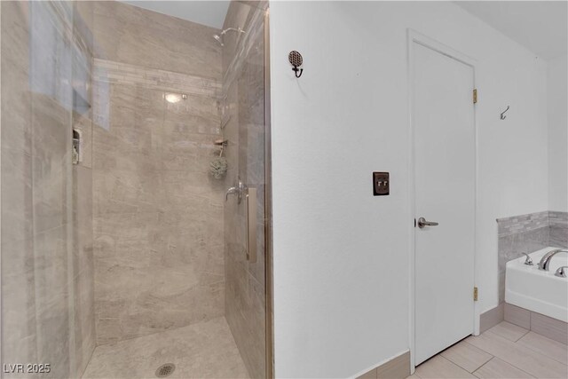 bathroom featuring tile patterned floors and shower with separate bathtub