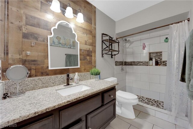 bathroom featuring tile patterned flooring, vanity, a shower with curtain, toilet, and wood walls