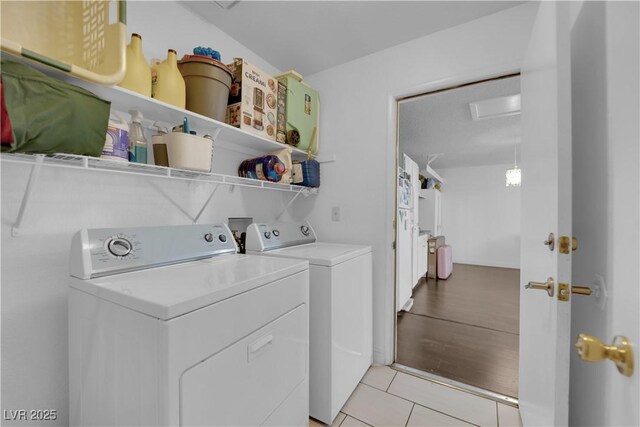 washroom with washer and dryer and light tile patterned floors