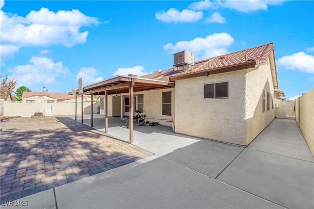 back of property with a patio area and central air condition unit