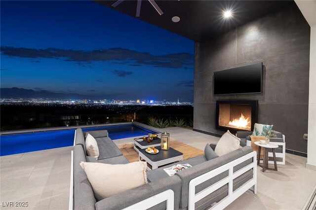 view of patio / terrace featuring an outdoor living space with a fireplace and a fenced in pool