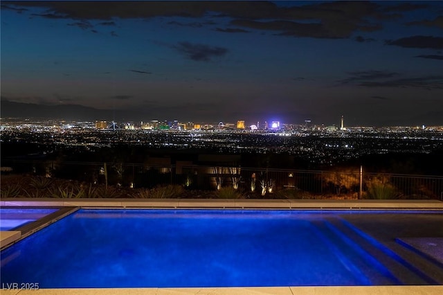 1 Boulderback Dr, Henderson, NV 89012 - pool at night with a view of city lights and a pool with connected hot tub