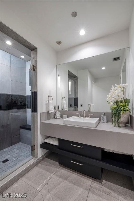 bathroom with an enclosed shower and vanity