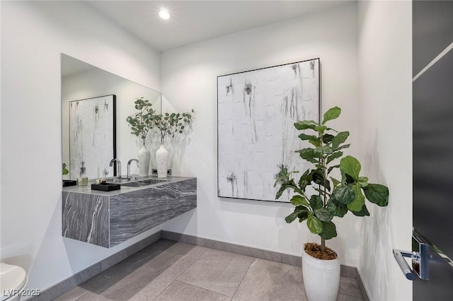 bathroom with tile patterned flooring and sink