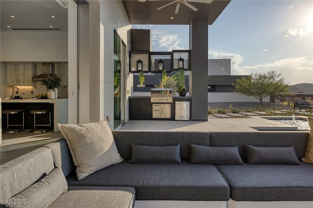 exterior space featuring ceiling fan, exterior kitchen, and area for grilling