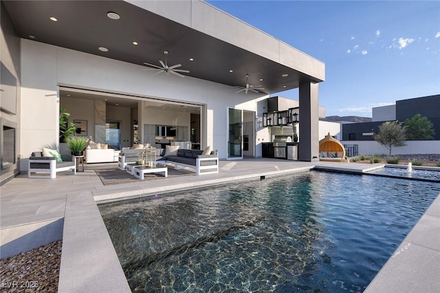 view of swimming pool with ceiling fan, an outdoor hangout area, and a patio area