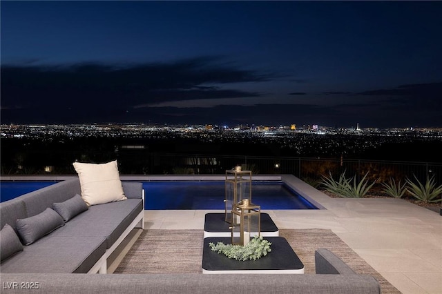 pool at twilight featuring an outdoor hangout area and a patio area