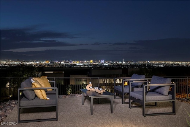 patio at night featuring an outdoor hangout area