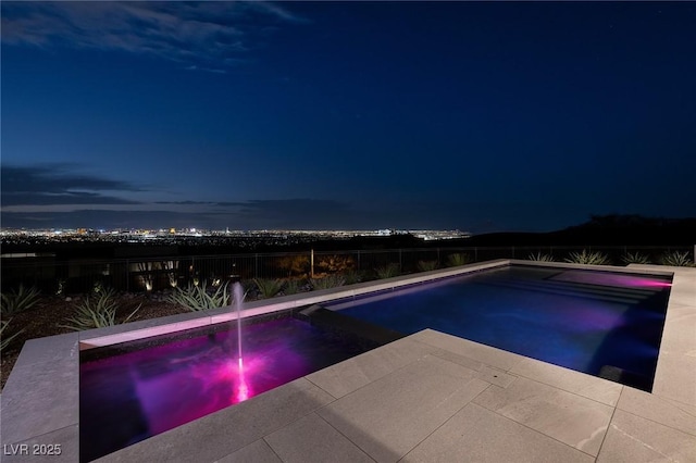 view of pool at night