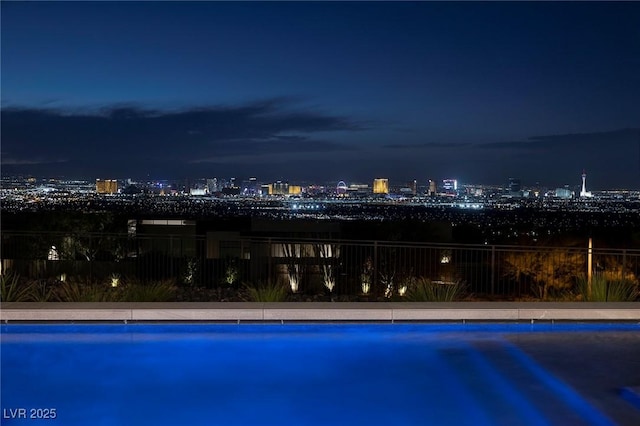 view of pool at twilight