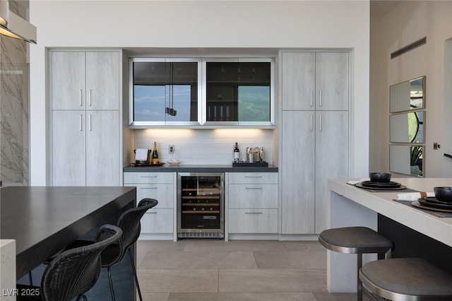 bar featuring wine cooler and backsplash