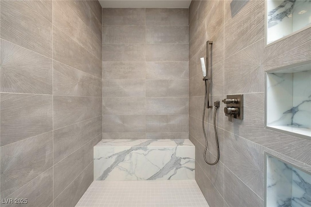 bathroom featuring a tile shower