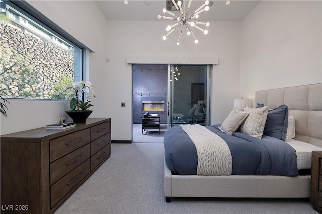 carpeted bedroom featuring a notable chandelier