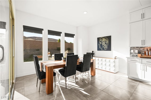 dining space featuring light tile patterned flooring