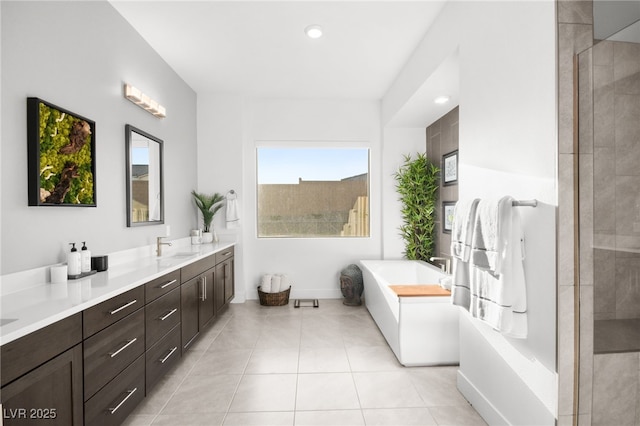 bathroom with vanity, tile patterned floors, and shower with separate bathtub