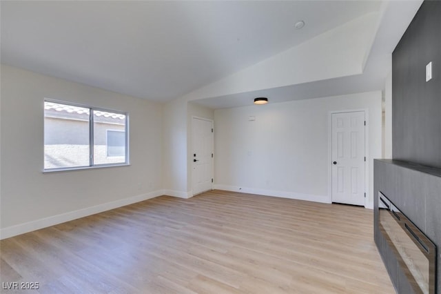 unfurnished living room with light hardwood / wood-style floors and lofted ceiling