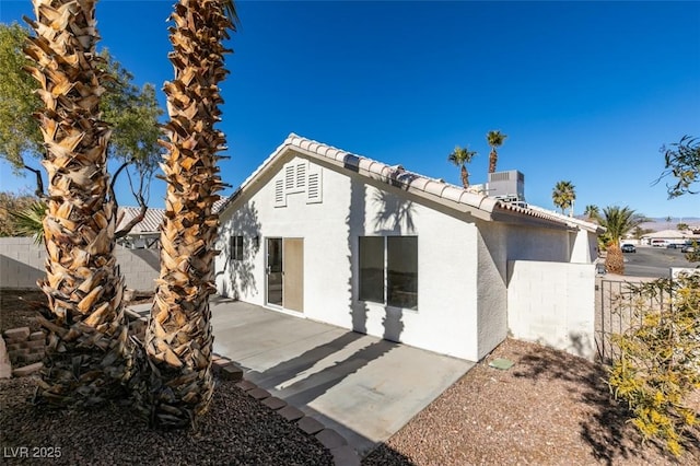 rear view of property with a patio area and central air condition unit