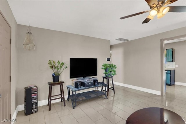 tiled living room with ceiling fan