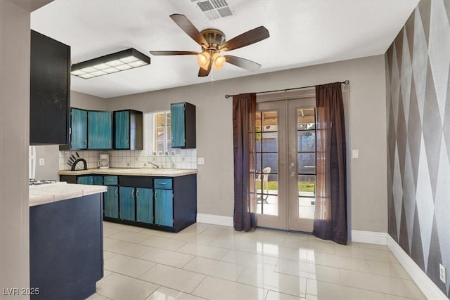 kitchen with ceiling fan, french doors, decorative backsplash, and blue cabinetry