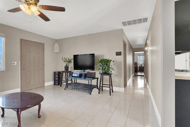 living room with ceiling fan and light tile patterned flooring