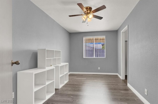 unfurnished bedroom featuring ceiling fan and dark hardwood / wood-style floors