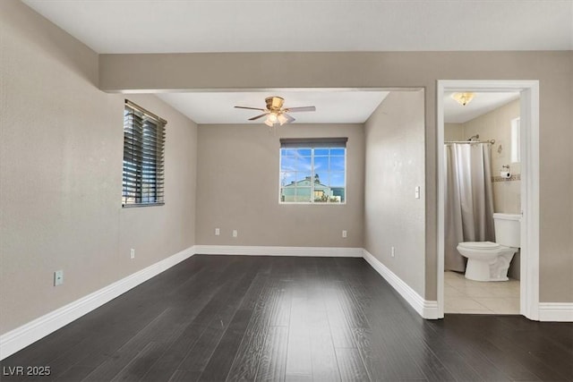 unfurnished room with ceiling fan and dark hardwood / wood-style flooring