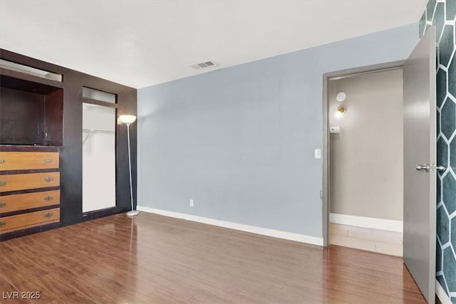 empty room with wood-type flooring