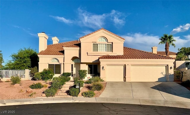 mediterranean / spanish home featuring a garage