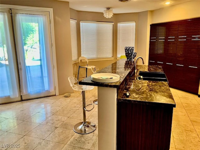 interior space featuring dark stone counters and sink